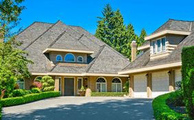 a house with a driveway and trees