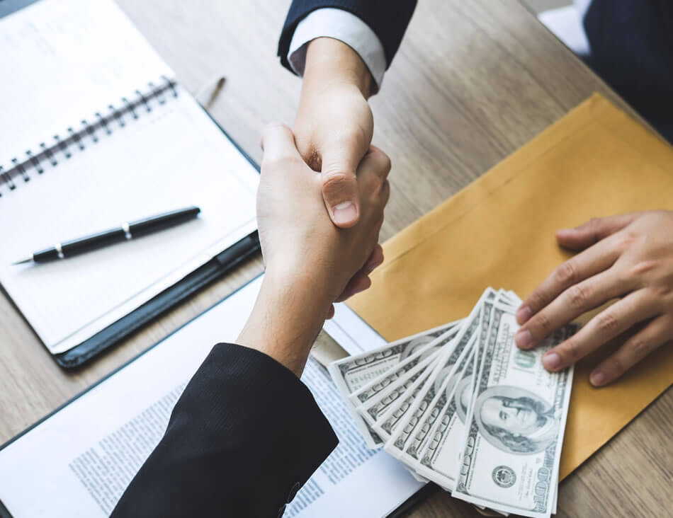 a hands shaking hands over money