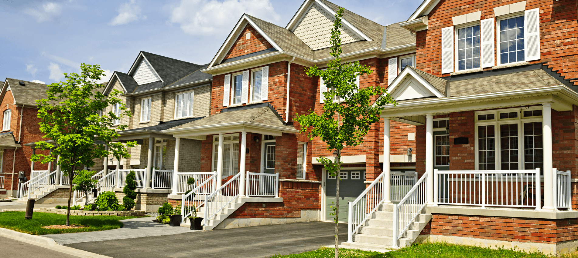 a row of houses with stairs and a tree